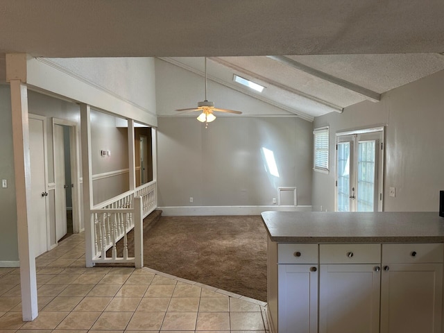 2827 Haverhill Cir N, Charleston, SC 29420 - kitchen featuring light colored carpet, light tile patterned flooring, a ceiling fan, white cabinets, and a textured ceiling