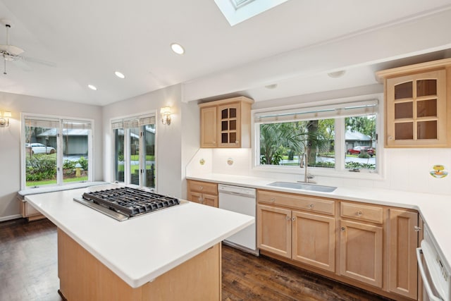 kitchen featuring light brown cabinetry, dishwasher, sink, dark hardwood / wood-style floors, and a kitchen island