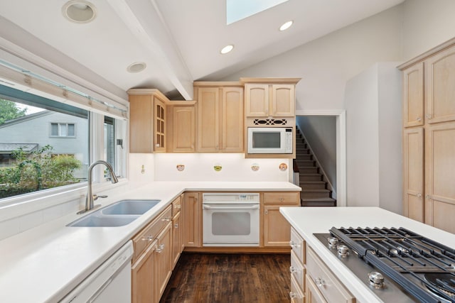 kitchen with white appliances, vaulted ceiling with beams, sink, dark hardwood / wood-style floors, and light brown cabinets