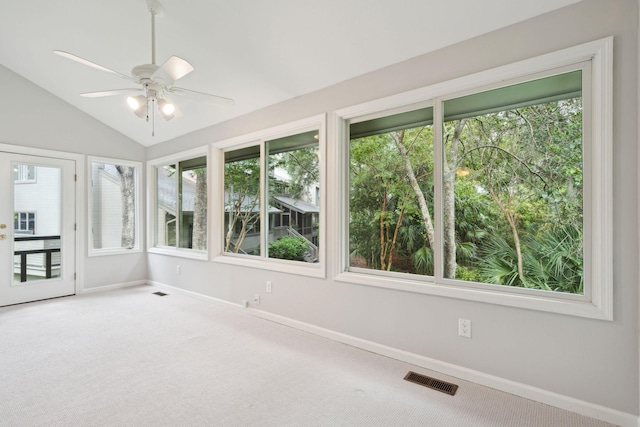 unfurnished sunroom with ceiling fan, plenty of natural light, and vaulted ceiling