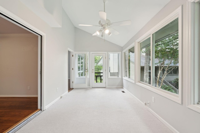 unfurnished sunroom with a healthy amount of sunlight, vaulted ceiling, and ceiling fan