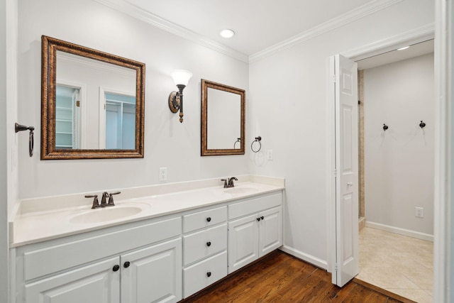 bathroom featuring hardwood / wood-style floors, crown molding, and vanity