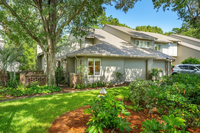 exterior space with a garage and a lawn