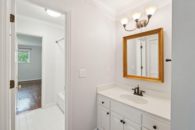 bathroom with crown molding, vanity, hardwood / wood-style floors, and bathing tub / shower combination