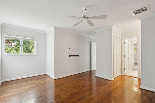 spare room with crown molding, dark hardwood / wood-style flooring, and ceiling fan