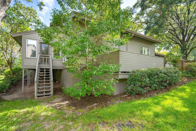 rear view of house featuring a lawn