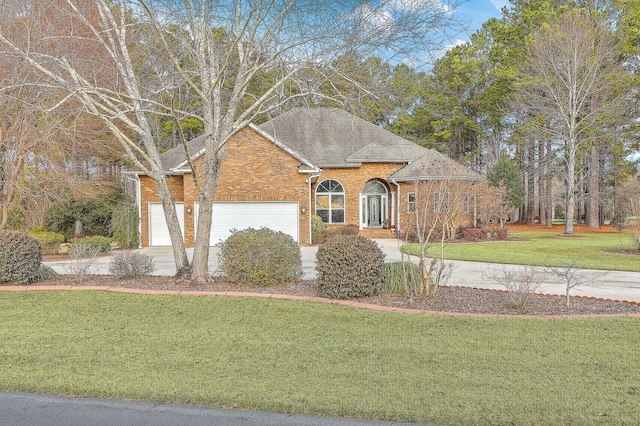 view of front of house with a garage and a front yard