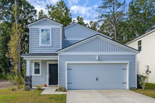 craftsman house with a front yard and a garage