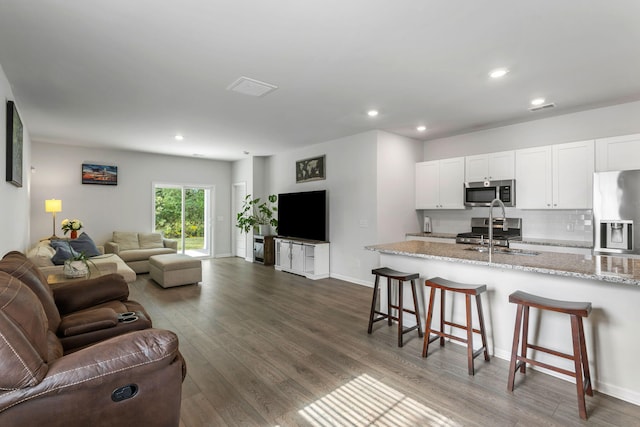 living room with sink and dark hardwood / wood-style flooring