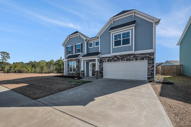 view of front facade featuring driveway, an attached garage, and fence