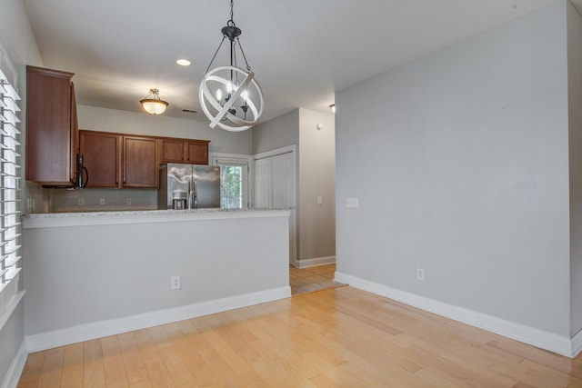 116 Venezia Ct, Ladson, SC 29456 - kitchen featuring stainless steel refrigerator with ice dispenser, a chandelier, a peninsula, pendant lighting, and light wood-style flooring