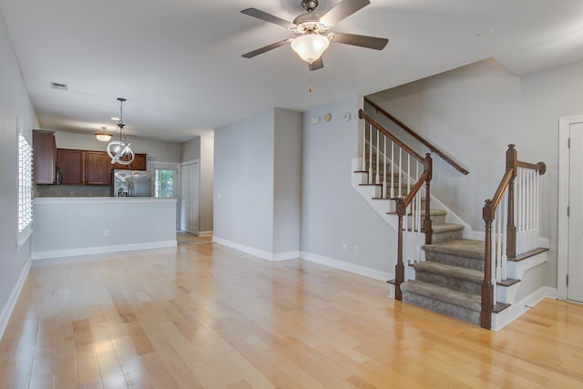 116 Venezia Ct, Ladson, SC 29456 - unfurnished living room featuring light wood finished floors, stairway, ceiling fan, and baseboards