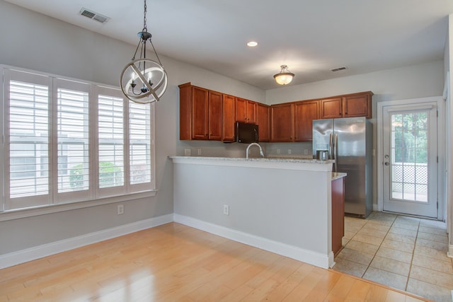 116 Venezia Ct, Ladson, SC 29456 - kitchen with stainless steel fridge, black microwave, a chandelier, a peninsula, and pendant lighting