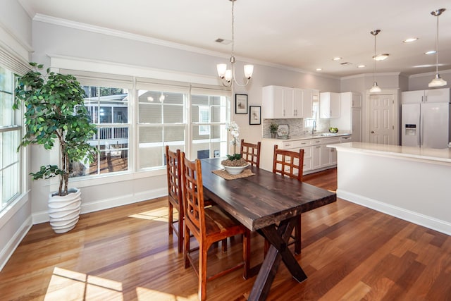 2517 Charter Oaks Dr, Mount Pleasant, SC 29466 - dining room featuring crown molding, plenty of natural light, light wood-style flooring, recessed lighting, and a chandelier