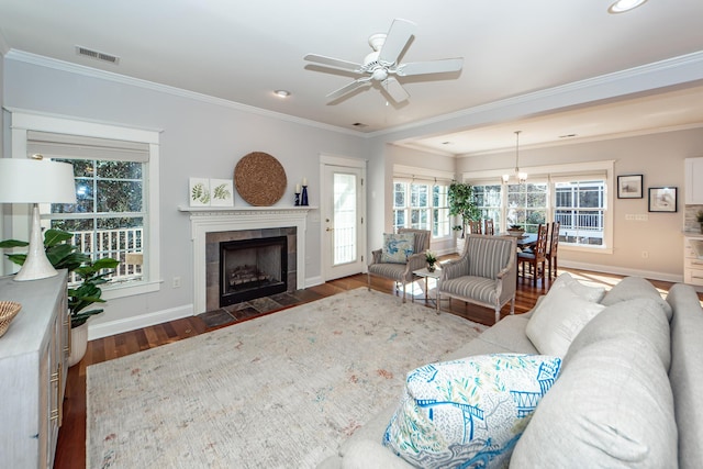 2517 Charter Oaks Dr, Mount Pleasant, SC 29466 - living area featuring ornamental molding, dark wood-style flooring, a tiled fireplace, ceiling fan, and recessed lighting