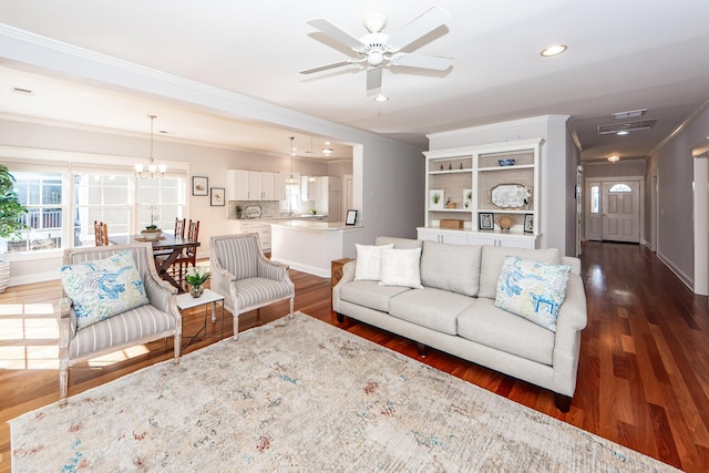 2517 Charter Oaks Dr, Mount Pleasant, SC 29466 - living room featuring crown molding, dark wood-style flooring, ceiling fan, recessed lighting, and a chandelier