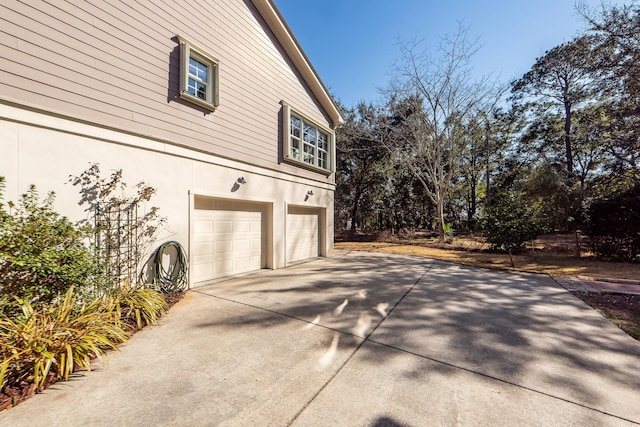 2517 Charter Oaks Dr, Mount Pleasant, SC 29466 - view of home's exterior with an attached garage, driveway, and stucco siding