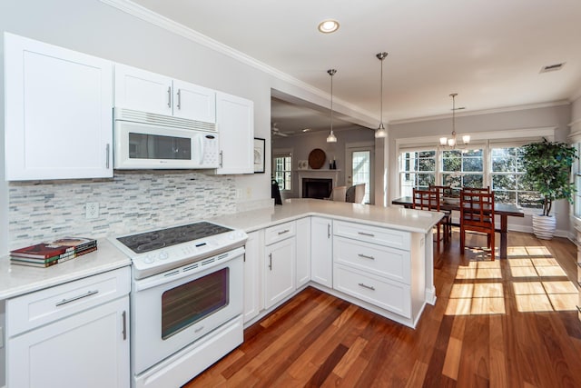 2517 Charter Oaks Dr, Mount Pleasant, SC 29466 - kitchen with white appliances, a peninsula, tasteful backsplash, ornamental molding, and light countertops