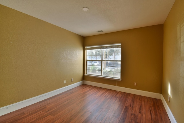 spare room with hardwood / wood-style flooring