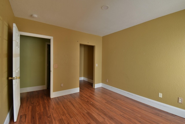 unfurnished bedroom featuring dark hardwood / wood-style floors