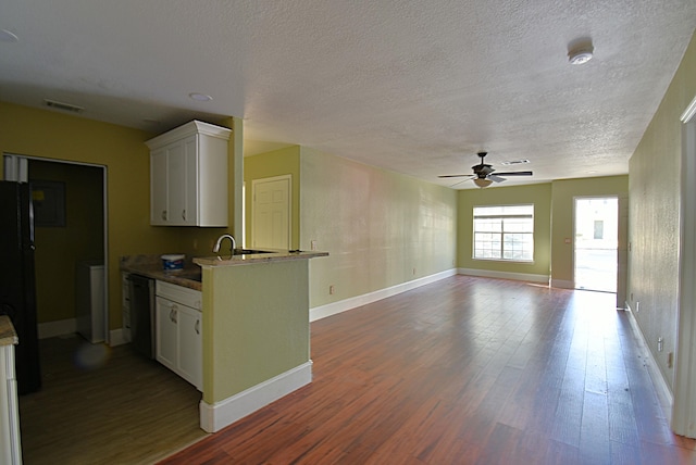 kitchen with dark wood-type flooring, ceiling fan, sink, and white cabinets