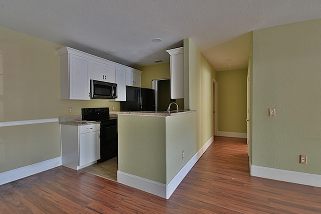 kitchen featuring white cabinetry, dark wood-type flooring, a textured ceiling, and black appliances