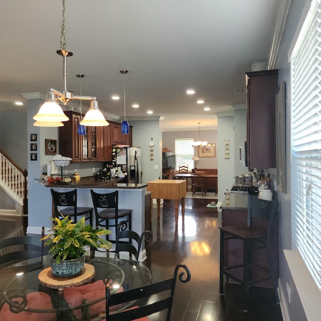 dining room featuring ornamental molding, dark wood-style floors, a chandelier, recessed lighting, and stairway