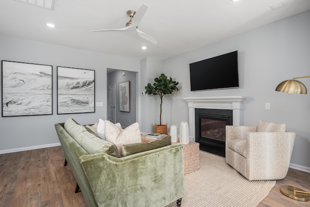 living room with ceiling fan and wood-type flooring