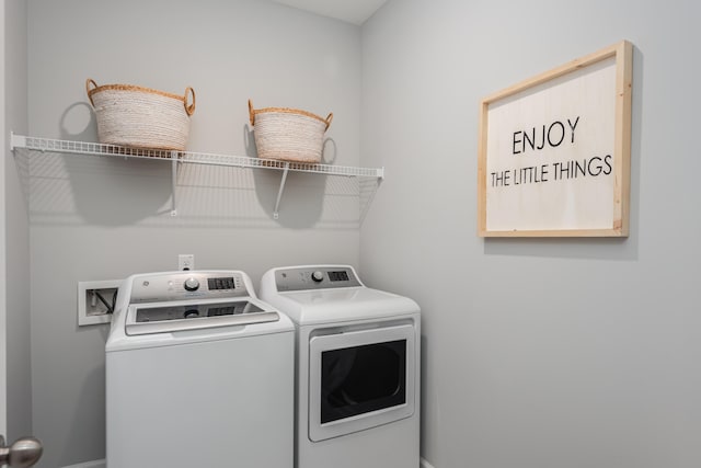 laundry room with washing machine and clothes dryer