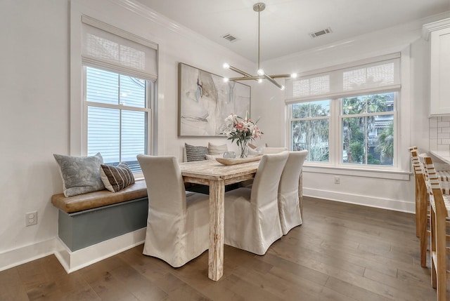 dining area featuring ornamental molding, a wealth of natural light, baseboards, and visible vents