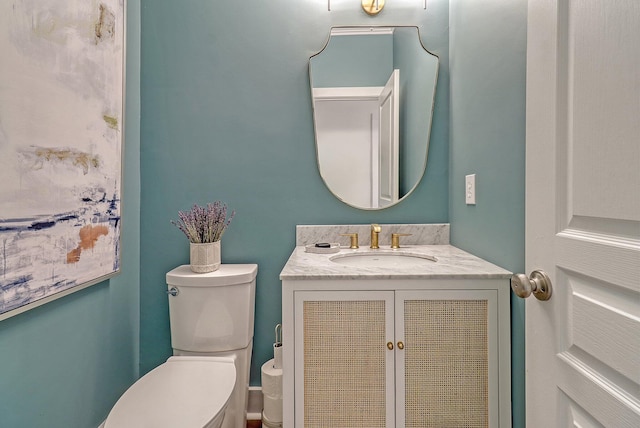 half bathroom featuring toilet and vanity