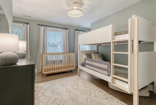 bedroom featuring visible vents and wood finished floors