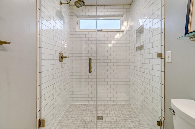 full bathroom featuring a stall shower and toilet