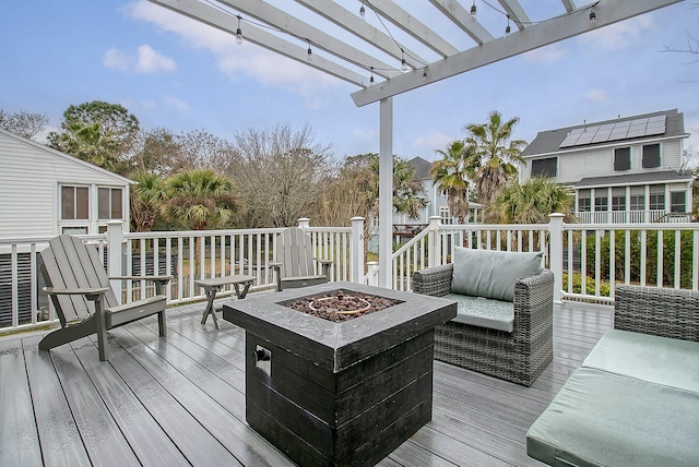 wooden deck with an outdoor living space with a fire pit and a pergola