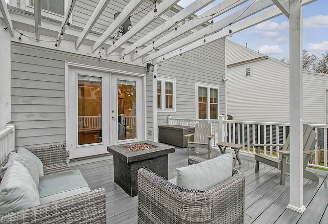 deck with a pergola and an outdoor living space with a fire pit