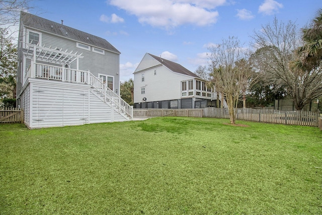 rear view of house featuring stairway, a fenced backyard, and a yard