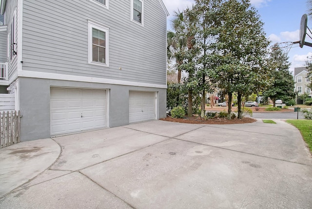 view of home's exterior featuring driveway, stucco siding, and an attached garage
