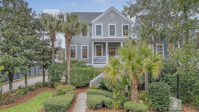 view of front of house with roof with shingles and covered porch
