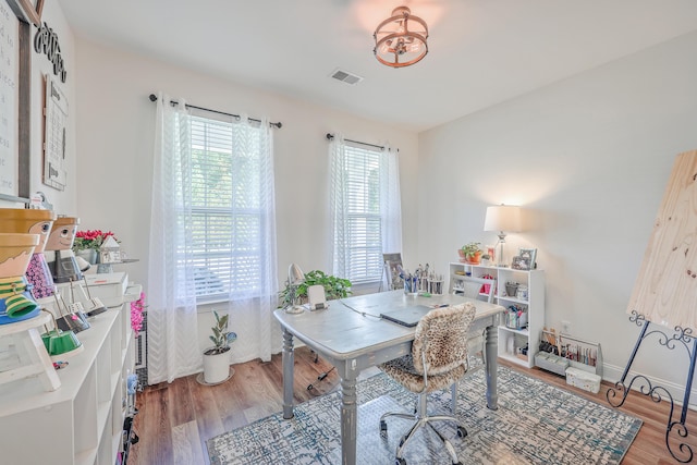 office area featuring wood finished floors and a chandelier
