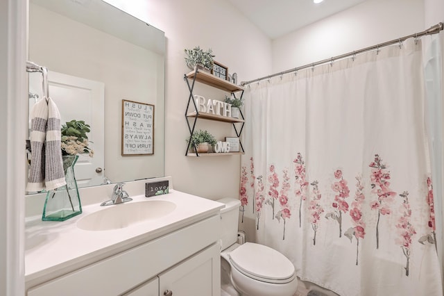 full bathroom with toilet and vanity