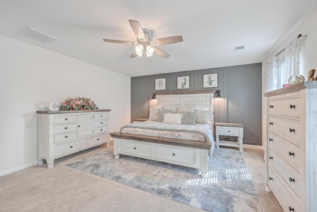 bedroom featuring light carpet and a ceiling fan