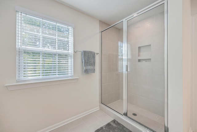 full bathroom featuring tile patterned flooring, plenty of natural light, and a stall shower