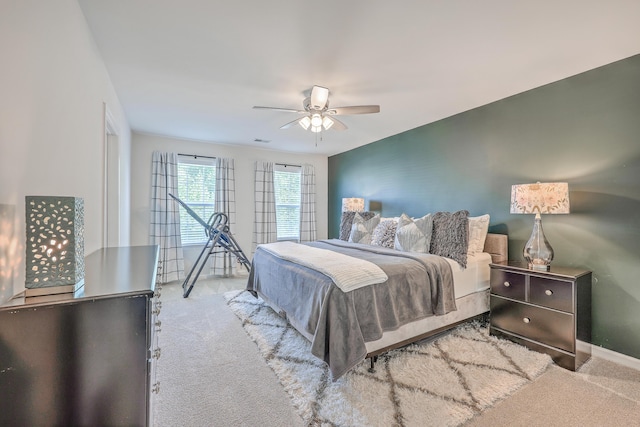 carpeted bedroom featuring baseboards and a ceiling fan