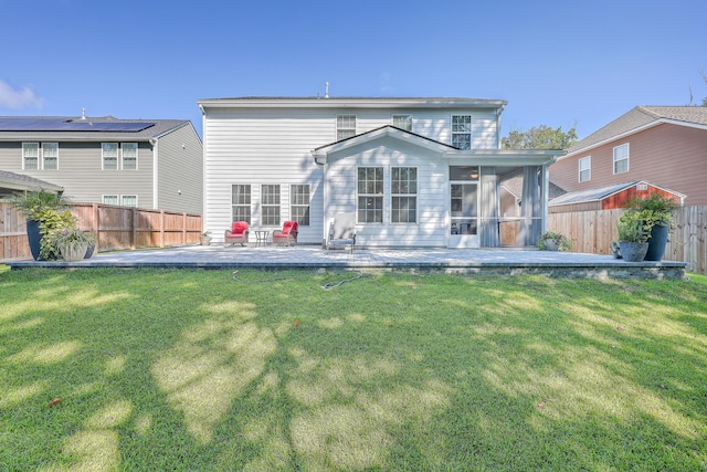 rear view of property featuring a sunroom