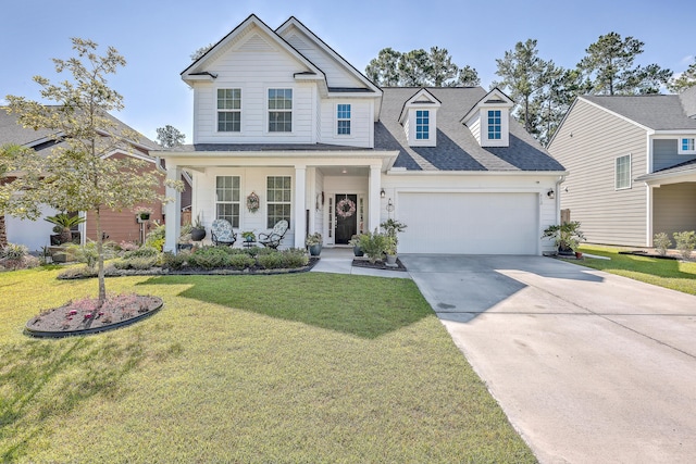 view of front facade featuring a garage, driveway, covered porch, a front lawn, and a shingled roof