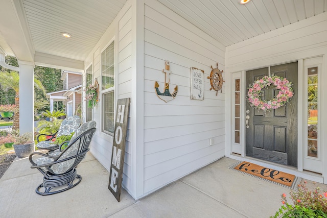 view of exterior entry with a porch