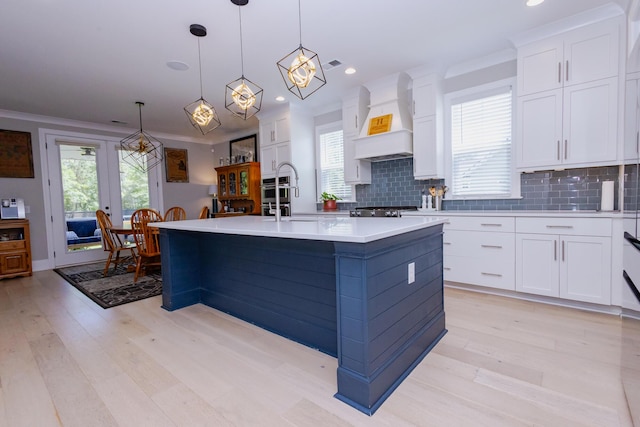 3025 Rampart Rd, Summerville, SC 29483 - kitchen featuring premium range hood, a sink, light wood-style flooring, light countertops, and recessed lighting
