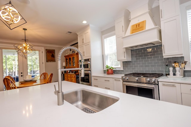3025 Rampart Rd, Summerville, SC 29483 - kitchen featuring stainless steel appliances, a chandelier, premium range hood, light countertops, and recessed lighting
