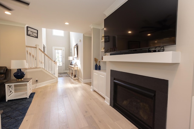 3025 Rampart Rd, Summerville, SC 29483 - living area featuring stairs, wood finished floors, baseboards, a glass covered fireplace, and recessed lighting
