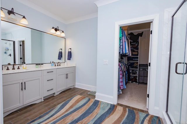 3025 Rampart Rd, Summerville, SC 29483 - full bathroom with a walk in closet, double vanity, a shower stall, wood finished floors, and ornamental molding